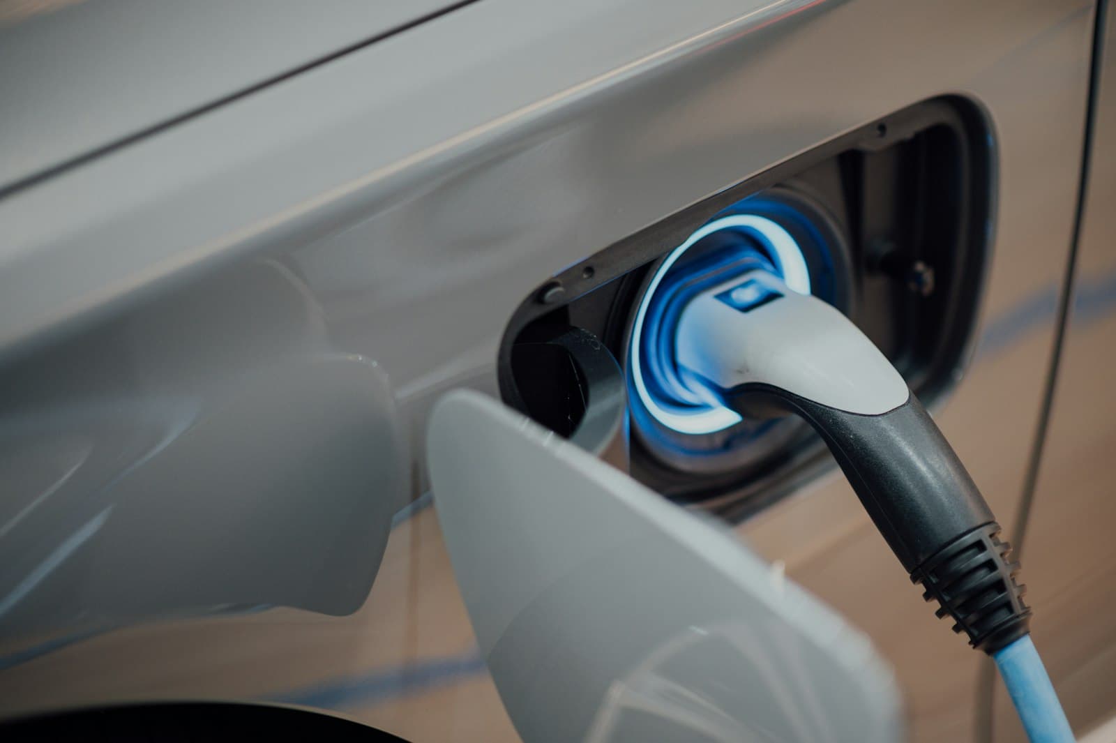 Electric vehicle plugged into a home charger at dusk