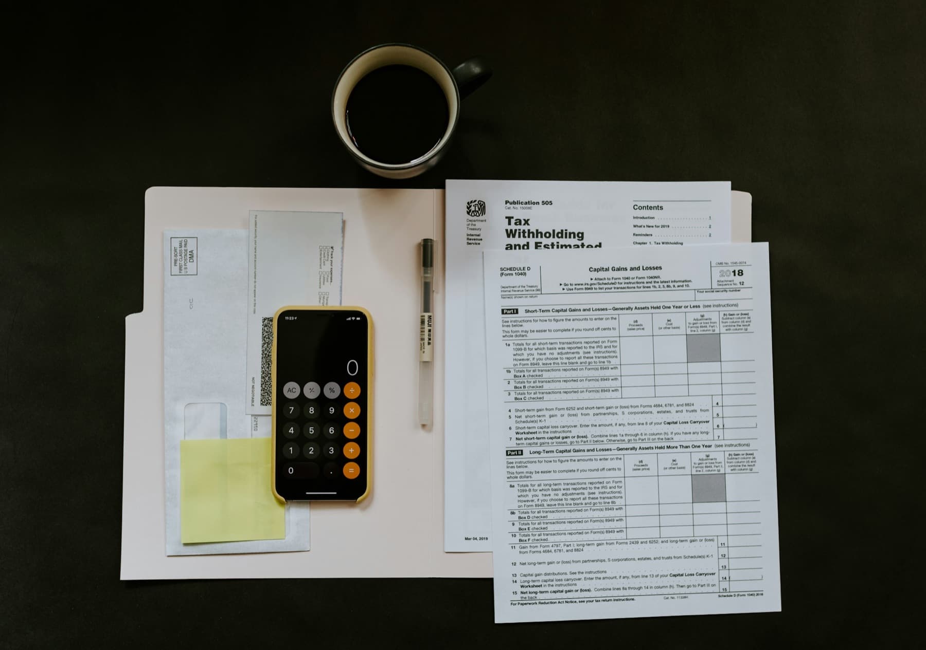 A small business owner reviewing finance documents at a desk near end of financial year.